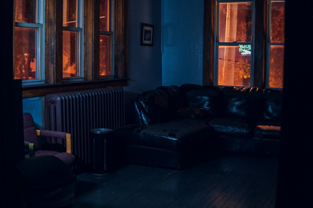 dark cozy homestay bedroom amber lighting wooden texture wall