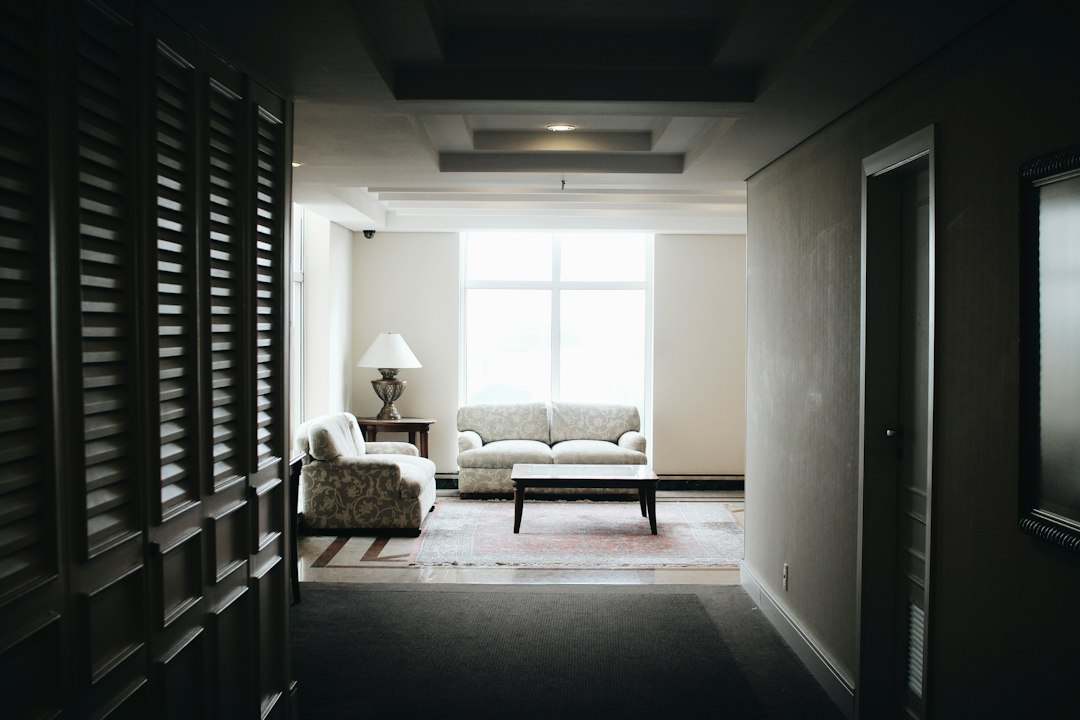 cinematic hotel room corridor warm light shadow play dark walls