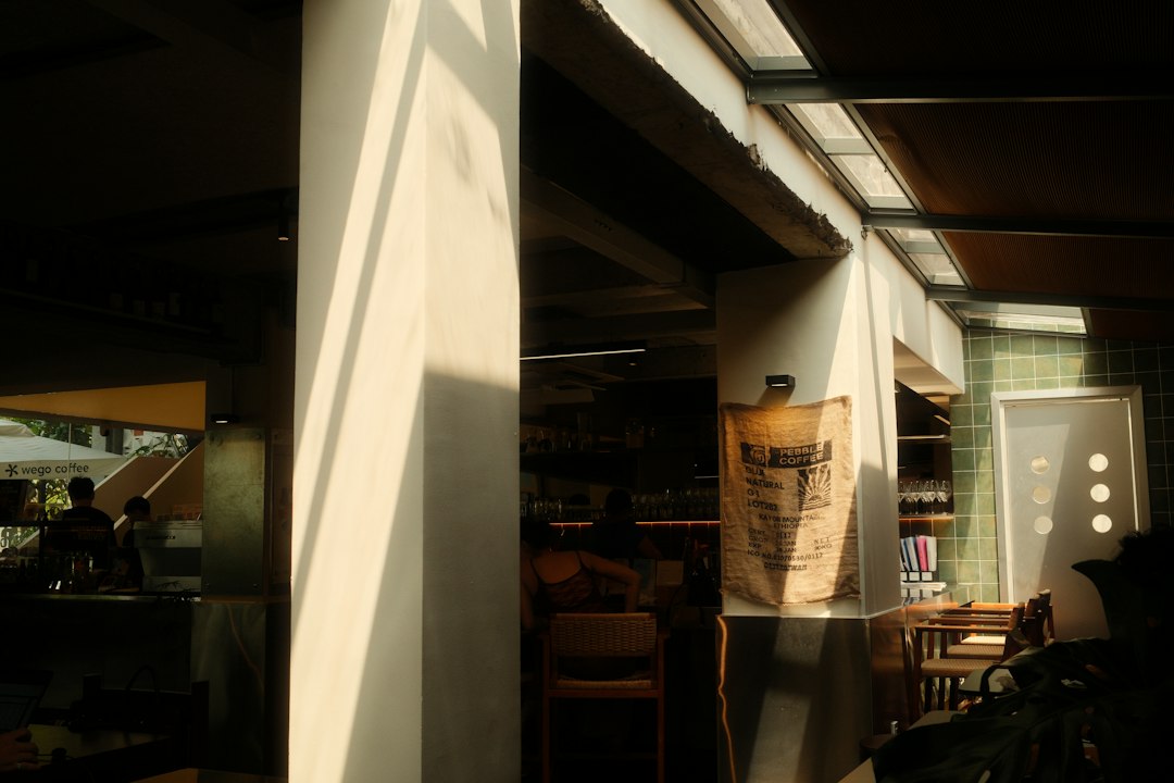 coffee shop counter bar stool dramatic shadow warm backlight