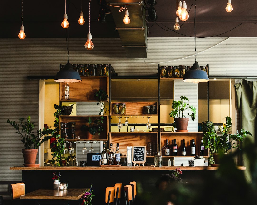 moody industrial cafe interior warm amber lighting dark walls