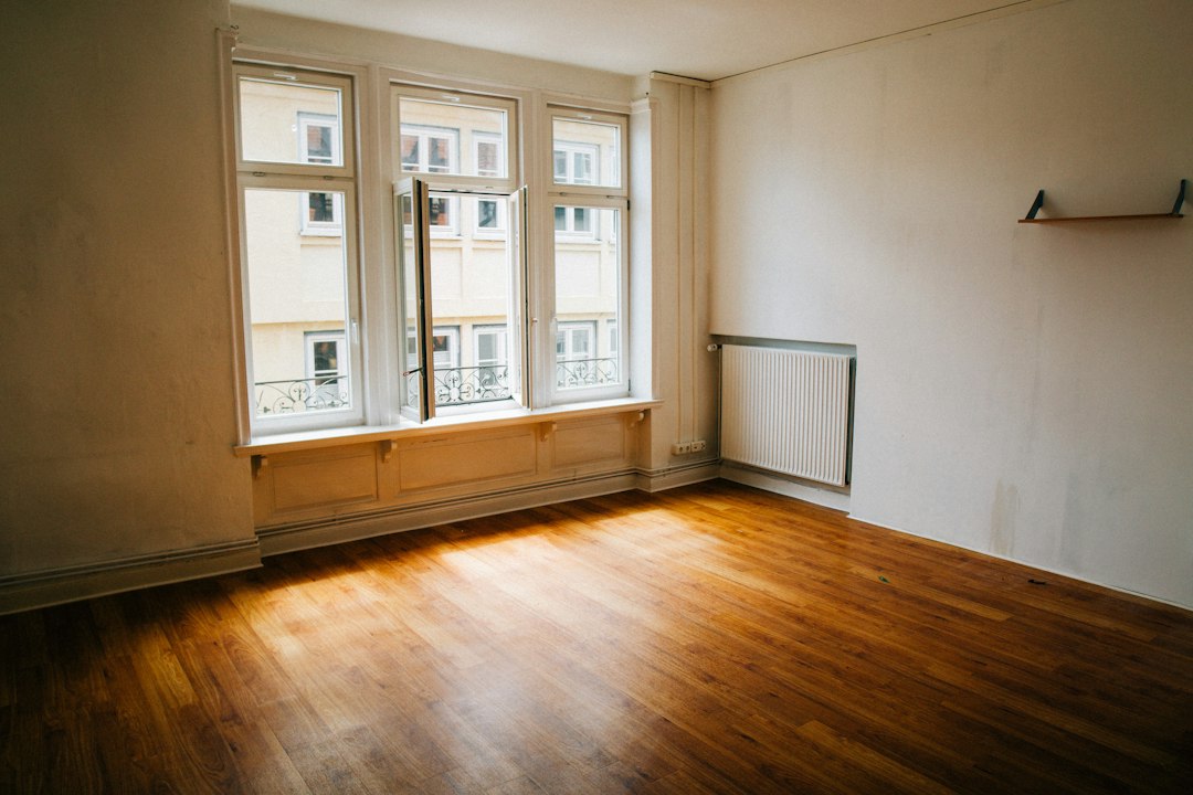empty apartment room with large window natural light minimal interior
