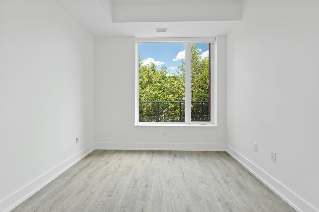 real estate photographer shooting empty room wide angle interior